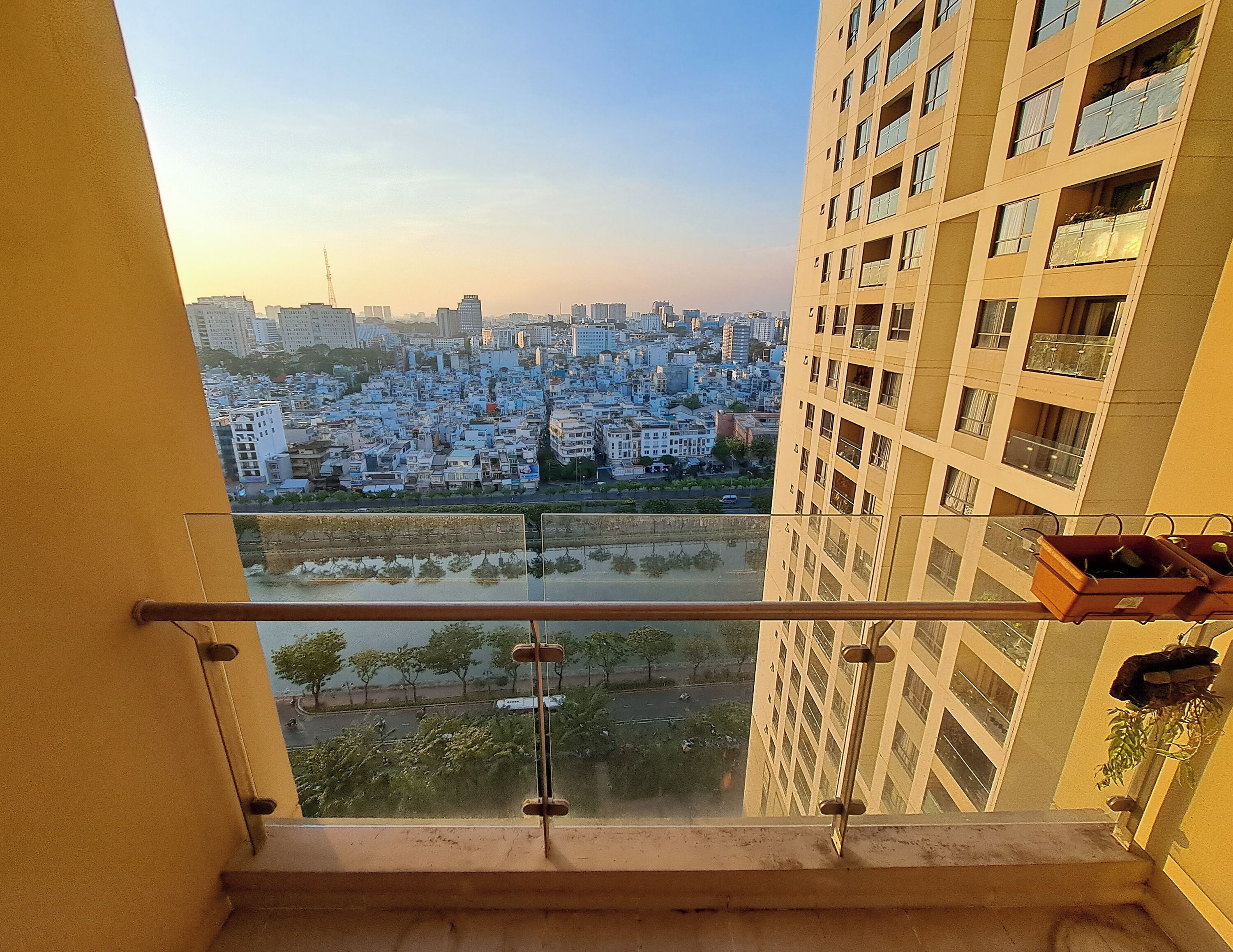 A high-rise building with a balcony overlooking a cityscape.