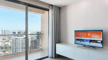 Deluxe Apartment | Living area | 50-inch Smart TV with cable channels, Netflix, streaming services