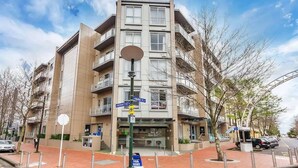 A multi-story residential building with balconies, a street sign, and a 'For Rent' sign. - The Vibe: Auckland CBD
 (Auckland)