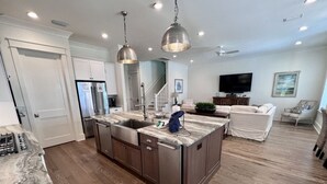 A spacious kitchen with a central island, stainless steel appliances, and pendant lighting. - Private Beach Access|Golf Cart|Pool|Spa|Bikes (Rosemary Beach)