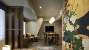 A modern interior with a dining area, sofa, and a decorative wall. - Minn Gion Sanjo (Kyoto)