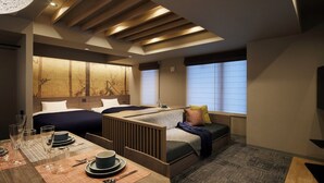 A modern hotel room with a bed, a sofa, a dining area with table and chairs, and a large window with blinds. - Minn Gion Sanjo (Kyoto)