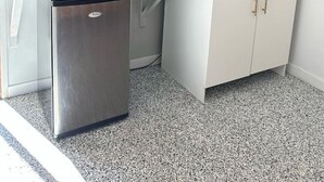 A compact kitchenette with a microwave, coffee maker, and a small refrigerator. - Clermont Guest House (Clermont)
