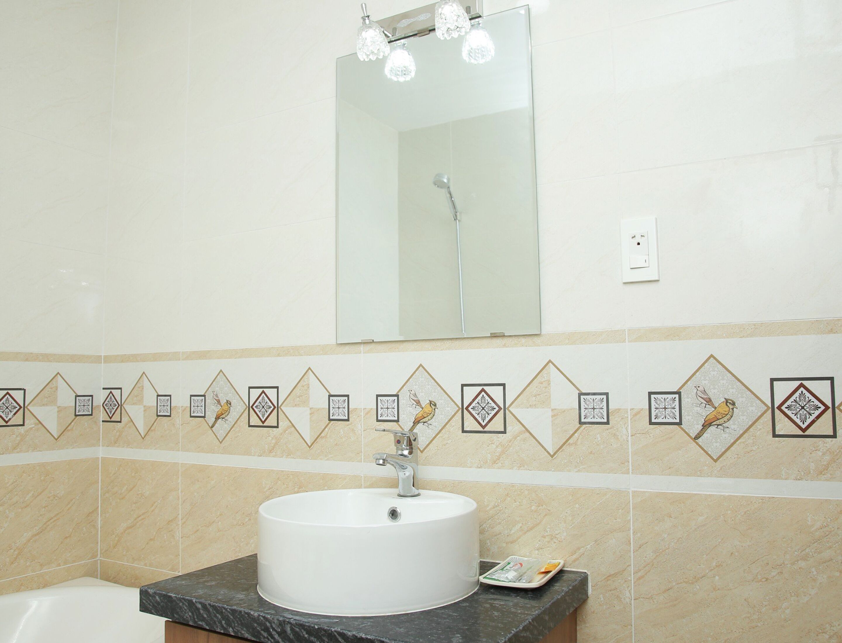 A bathroom with a white sink, a mirror, and a shower.