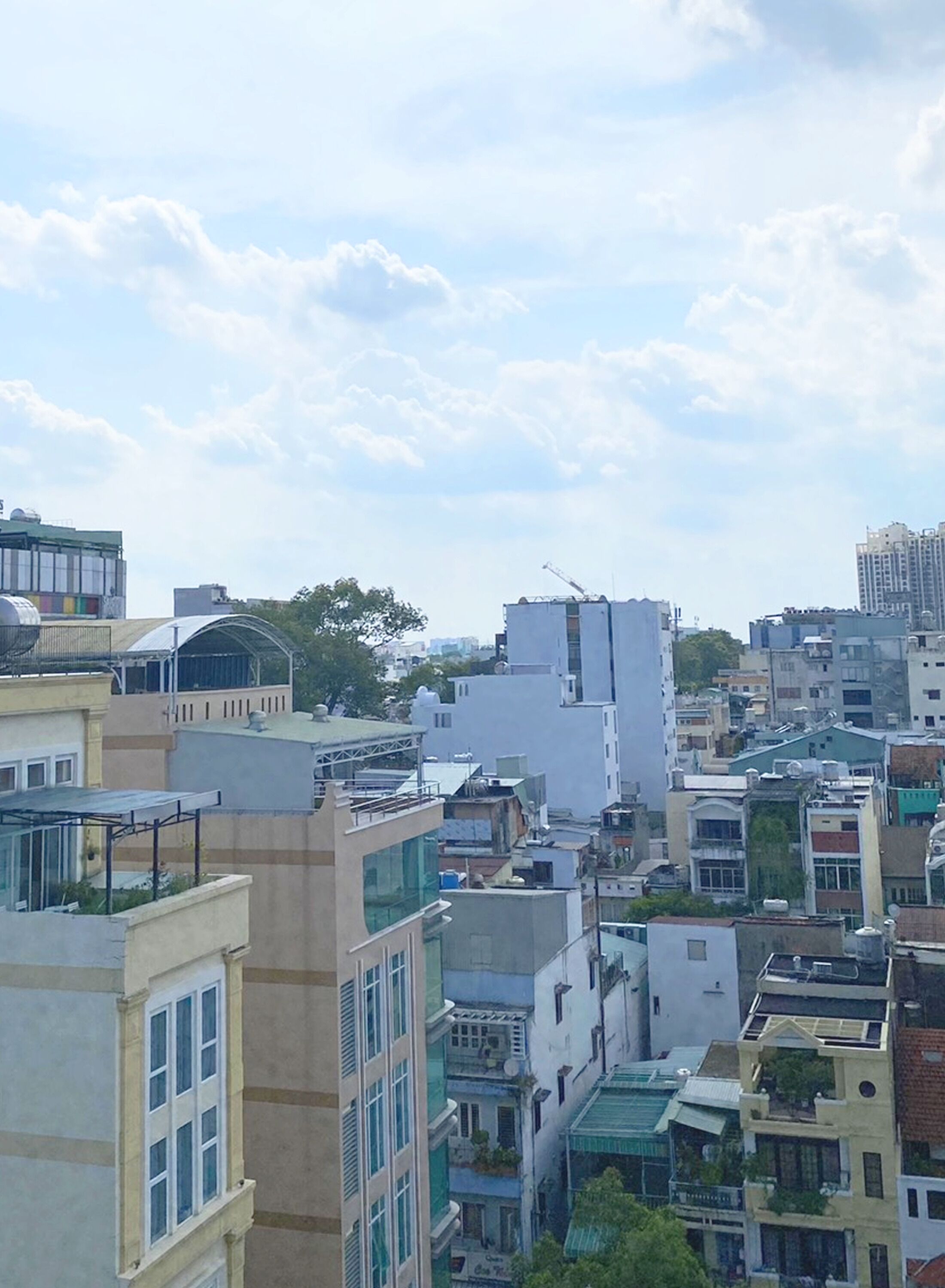 A densely packed urban area with various multi-story buildings, some with visible balconies and windows.