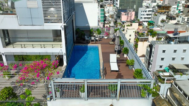 A rooftop pool with a view of the city, a sign reading 'Lighthouse Laigon,' and a white building with balconies. - CityHouse NEST LightHouse Saigon (Ho Chi Minh City)
