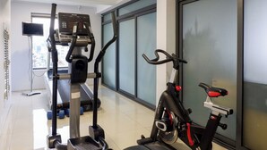 A gym with exercise equipment, a treadmill, and a stationary bike. - CityHouse NEST LightHouse Saigon (Ho Chi Minh City)