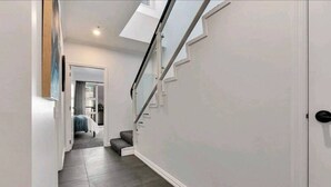 A narrow hallway with a staircase leading to another room. - Princess Wharf w/ Balcony

 (Auckland)