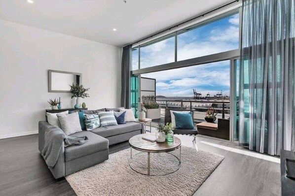 Relax in this stylish living room with a city view, featuring a sofa, coffee table, and side table.