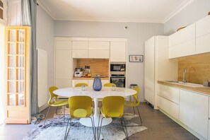 Enjoy meals in the kitchen with a central island and dining area, featuring an oven and microwave.