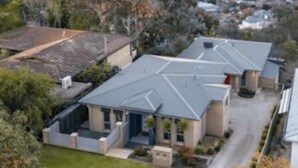 A residential area with houses featuring sloped roofs and a large tree in the foreground. - Divine Views on Roper - Glorious three bedroom, two bathroom townhouse with views to die for! (Albury)