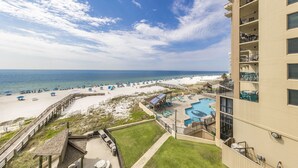 A resort with a pool, beach, and ocean view.