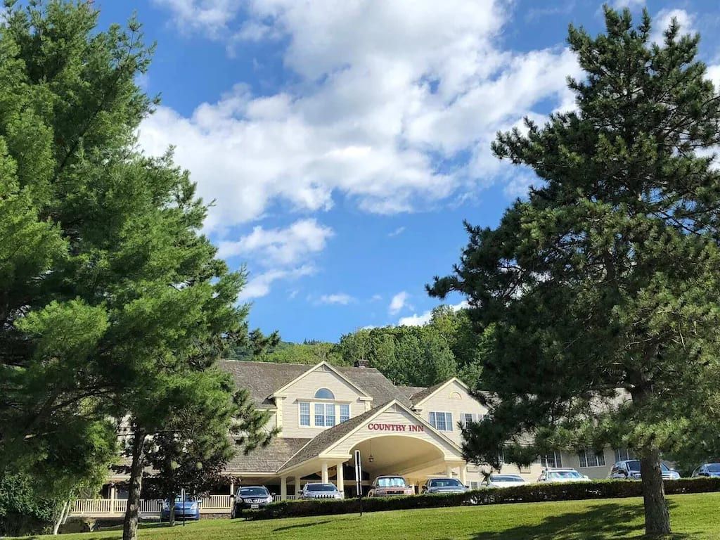 A Country Inn with a large, welcoming entrance and multiple parking spaces.