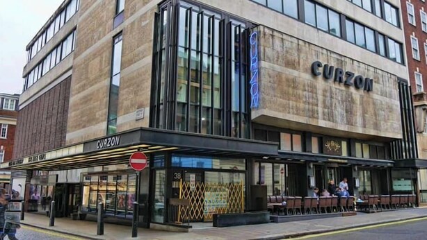 A modern building with a sign reading "CURZON" on the facade.