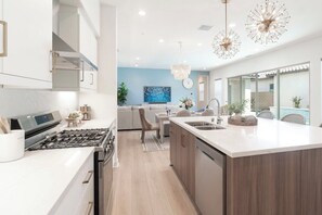 Enjoy cooking in this well-equipped kitchen with a gas stove and dishwasher, plus ample workspace at the large island with sink.