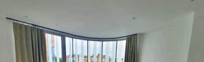 Enjoy a city view from the large window, dressed with curtains for your comfort.