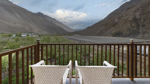 A balcony with a view of a river and mountains. - Echor Mud Huts Tabo Spiti Valley (Spiti)