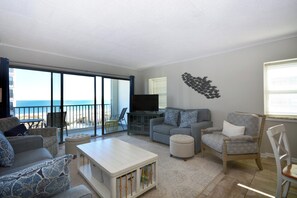 Living area - eclectic, cozy 3 bedroom condo with wiFi, flat screen televisions, books, and a distant ocean view located uptown near mini golf and a movie theater and a mere stroll to the beach! (Ocean City)