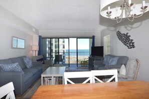 Living area - eclectic, cozy 3 bedroom condo with wiFi, flat screen televisions, books, and a distant ocean view located uptown near mini golf and a movie theater and a mere stroll to the beach! (Ocean City)