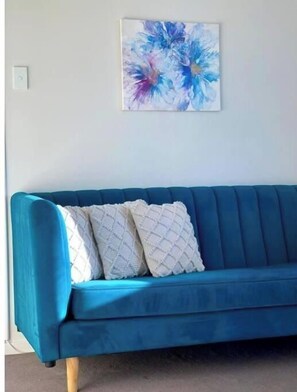 Relax in a serene space with a sofa and artwork above.