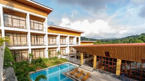 A hotel with multiple floors, a swimming pool, and a view of the surrounding landscape. - Sea Hills Resort Havelock (Port Blair)