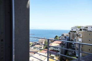 A coastal cityscape with buildings and a view of the sea.