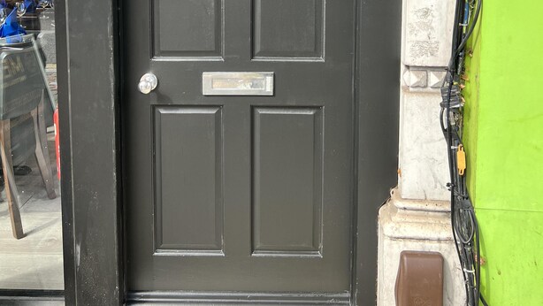 A black door with the number 14A, a small mailbox, and a security device on the wall. - 1-bed Apartment in Ealing, 3 Mins From Station (London)