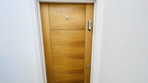 A wooden door with a number '4' and a keypad lock. - 1-bed Apartment in Ealing, 3 Mins From Station (London)