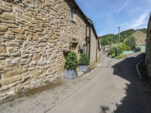 A stone building with a sign indicating it is a hotel.