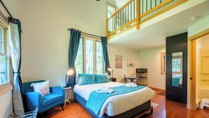A bedroom with a bed, a chair, a desk, and a window. - Walkable Ephraim Duplex | Fall Days & Cozy Nights (Ephraim)