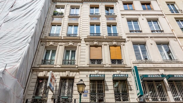 A multi-story building with the name 'AVANEZ' on the facade.
