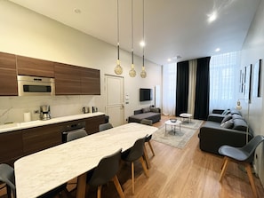 Enjoy meals and gatherings in the spacious living area with a sofa set and dining table.
