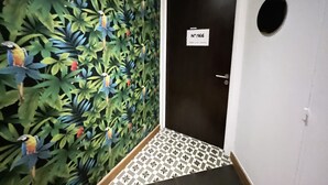 A hallway with a door labeled "No:166" and a wall mural of birds and foliage. - Urban Flat 166 - 4BDR Luxury Apartment in Center of Paris (París)