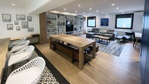 A modern living room with a wooden table, white chairs, a grey sofa, and a bookshelf. - Urban Flat 166 - 4BDR Luxury Apartment in Center of Paris (París)