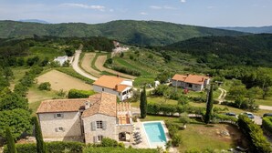 A villa with a swimming pool, surrounded by lush greenery and hilly terrain. - Beautiful Villa Habibi with pool (Sovinjak)