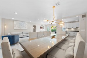 Dining room area with sofa, dining table and swivel chairs