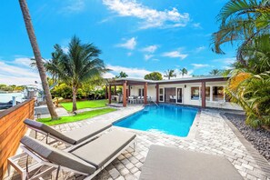 Outdoor heated pool w/ jacuzzi and lounge chairs