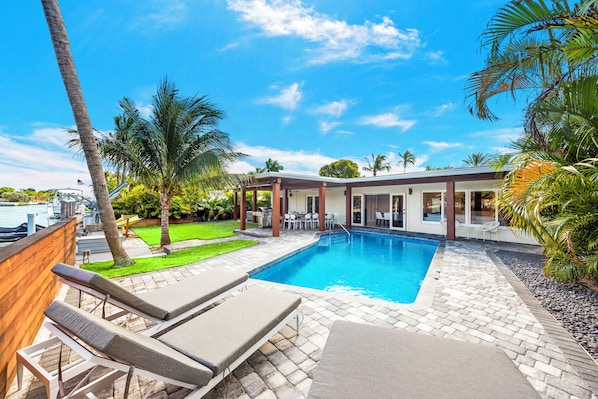 Outdoor heated pool w/ jacuzzi and lounge chairs