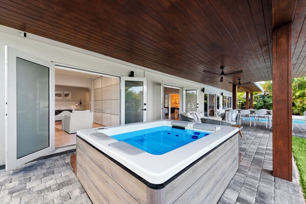 Outdoor heated pool w/ jacuzzi and outdoor seating  