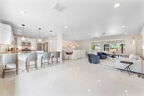 Dining room area with sofa, dining table and swivel chairs