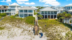A beachfront property with multiple houses, a wooden boardwalk, and a sandy beach. - Seaview Villas by Panhandle Getaways (Santa Rosa Beach)