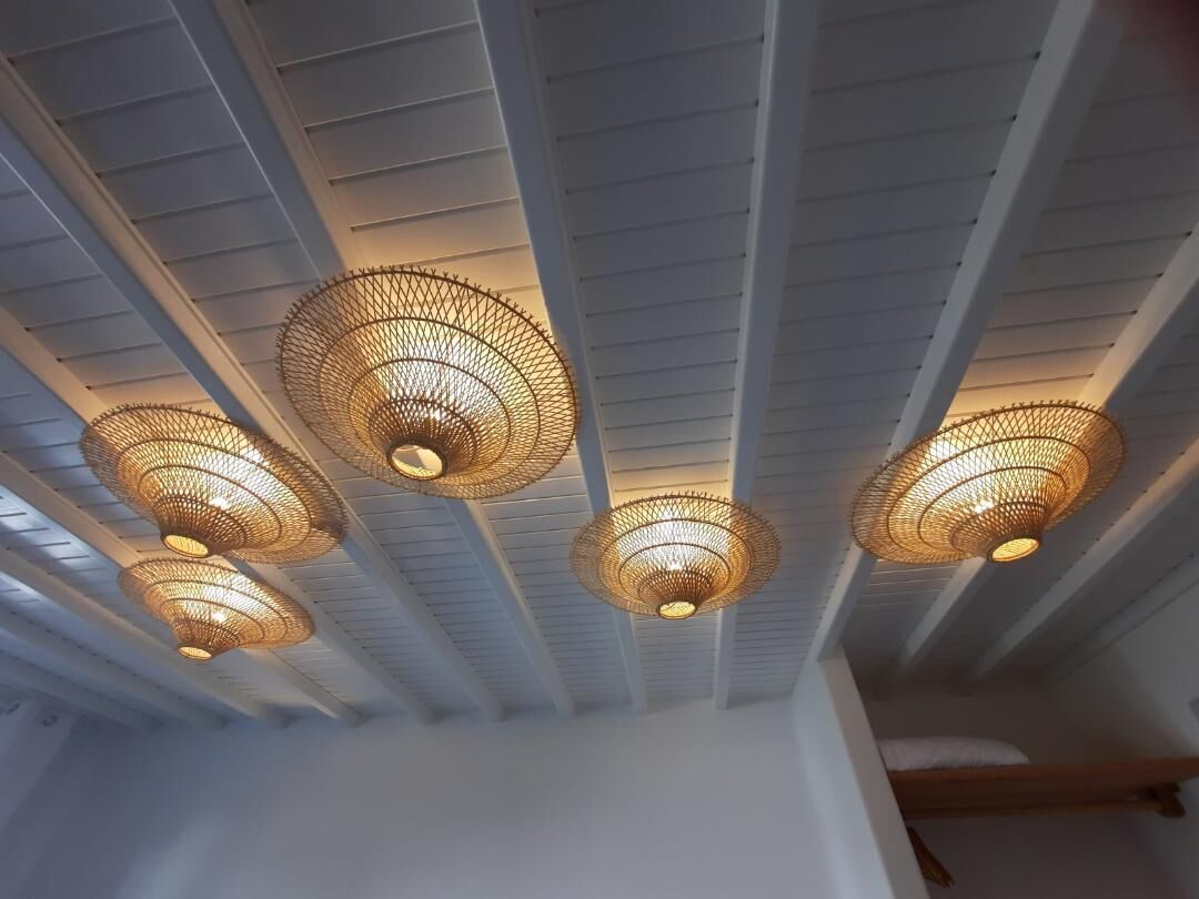 A ceiling with multiple woven light fixtures.