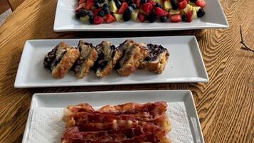 A table with three square plates of food.