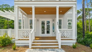 A white house with a porch, wooden steps, and a mailbox. - 30A Beach House - 30A Wonderland by PHG (Panama City Beach)