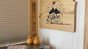 Una kitchenette con un letrero de madera sujeto a la pared que dice "Explore More".
