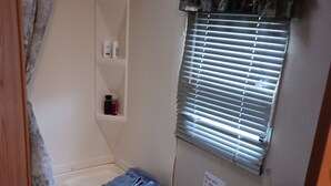 A compact bathroom with a toilet, sink, and shower area. - Camp Lilybug-Calm Oasis Pet Friendly! (Terre Haute)