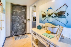 Enjoy a personal touch in this inviting space with a chalkboard wall, desk, and nautical-themed decor.