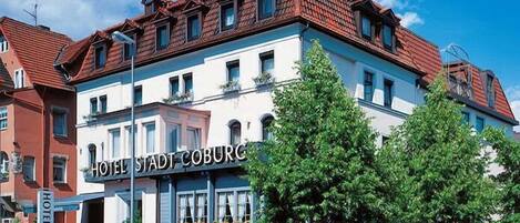 A hotel with a traditional European architectural style, featuring a prominent sign that reads "HOTEL STADT COBURG".