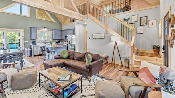 A spacious living area with a wooden ceiling, a staircase, and a kitchen in the background. - ATV Trailer Parking/NEW/5 min to Natural Bridge (Campton)
