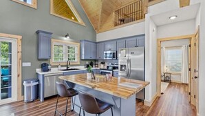 A modern kitchen with a wooden island, grey cabinets, and stainless steel appliances. - ATV Trailer Parking/NEW/5 min to Natural Bridge (Campton)